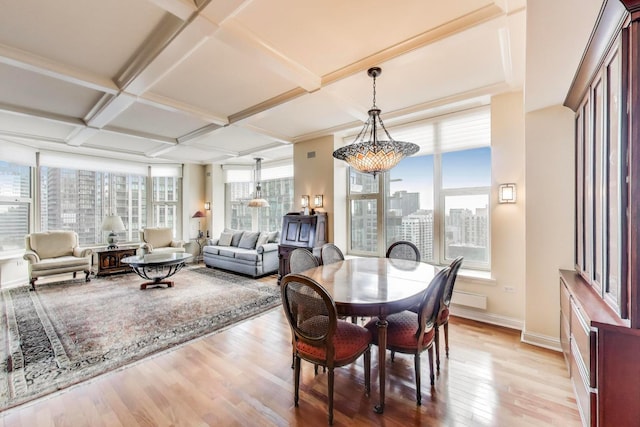 25 E Superior St Unit 2501, Chicago, IL 60611 - dining area with light wood-style floors, baseboards, coffered ceiling, and beamed ceiling