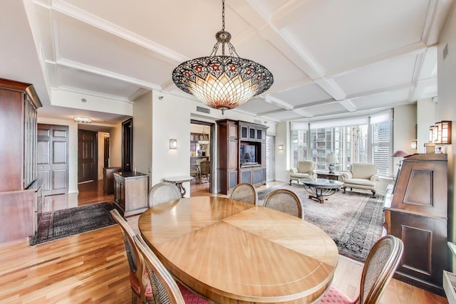 25 E Superior St Unit 2501, Chicago, IL 60611 - dining space featuring light wood-type flooring, coffered ceiling, beamed ceiling, and ornamental molding