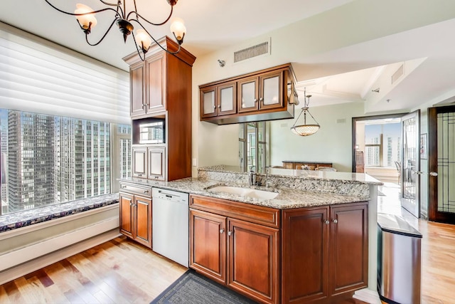 25 E Superior St Unit 2501, Chicago, IL 60611 - kitchen featuring white dishwasher, a sink, light wood-style flooring, a chandelier, and light stone counters