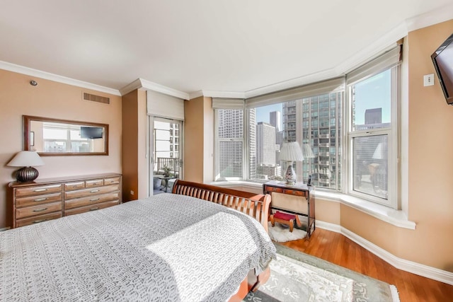 25 E Superior St Unit 2501, Chicago, IL 60611 - bedroom featuring wood finished floors, crown molding, and baseboards