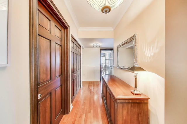 25 E Superior St Unit 2501, Chicago, IL 60611 - hall with light wood finished floors, crown molding, and a wainscoted wall