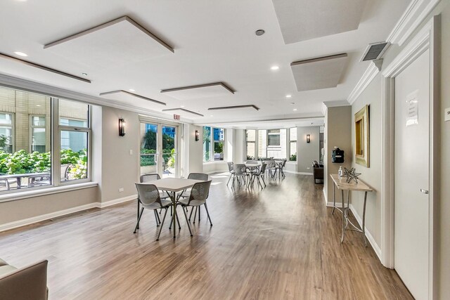 25 E Superior St Unit 2501, Chicago, IL 60611 - dining space with wood finished floors, ornamental molding, baseboards, and recessed lighting