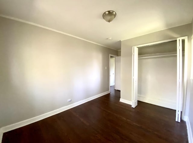 15234 Meadow Ln, Dolton, IL 60419 - unfurnished bedroom featuring dark wood-style flooring, baseboards, a closet, and ornamental molding