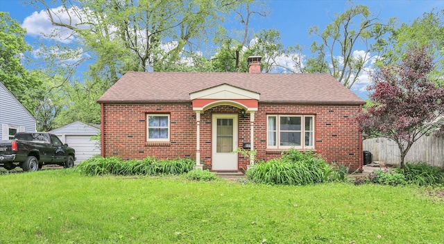809 Hawthorne Dr, Urbana, IL 61801 - bungalow-style house featuring brick siding, a chimney, roof with shingles, and a detached garage