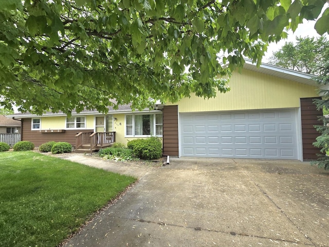 ranch-style house featuring driveway, a garage, and a front lawn