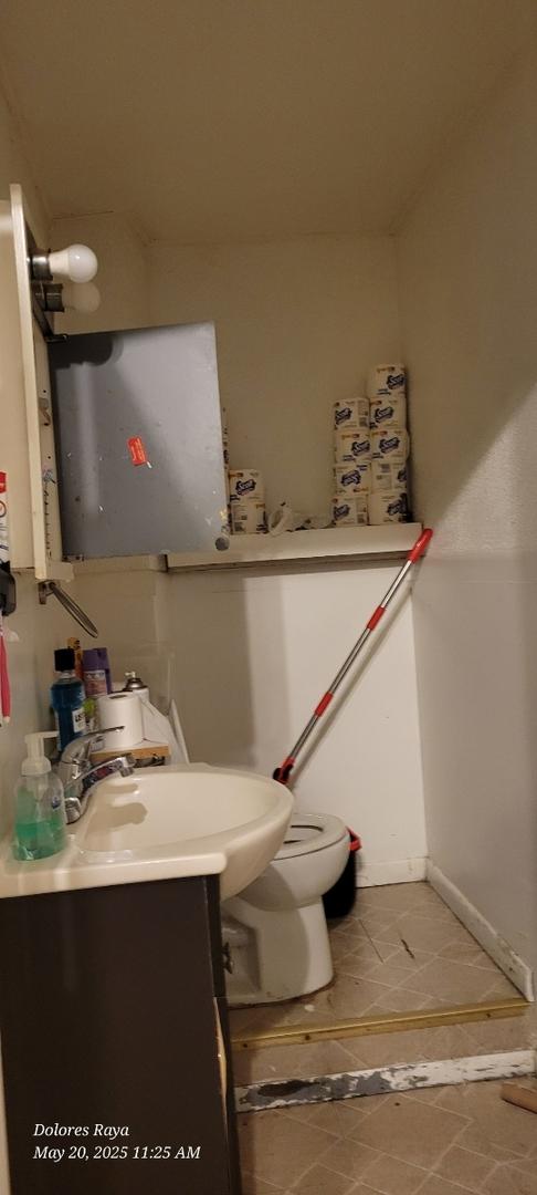 1507 W Erie St, Chicago, IL 60642 - half bath with vanity, baseboards, and toilet