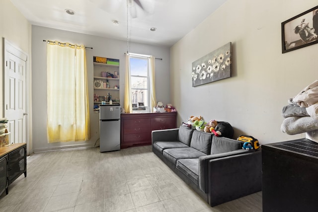 living area with a ceiling fan