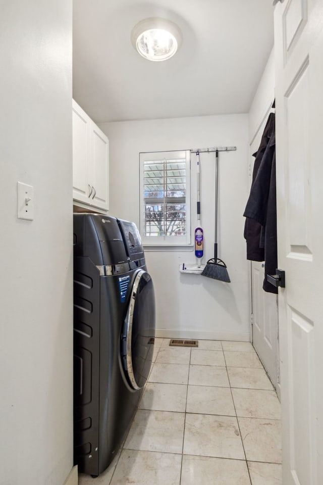 2105 Primrose Dr, Plainfield, IL 60586 - clothes washing area featuring cabinet space, light tile patterned floors, and washing machine and dryer