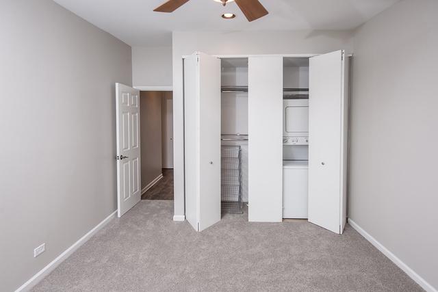 unfurnished bedroom featuring stacked washer / drying machine, carpet flooring, baseboards, ceiling fan, and recessed lighting