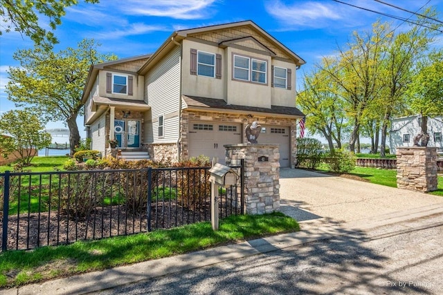 view of front facade featuring concrete driveway, a garage, and stone siding