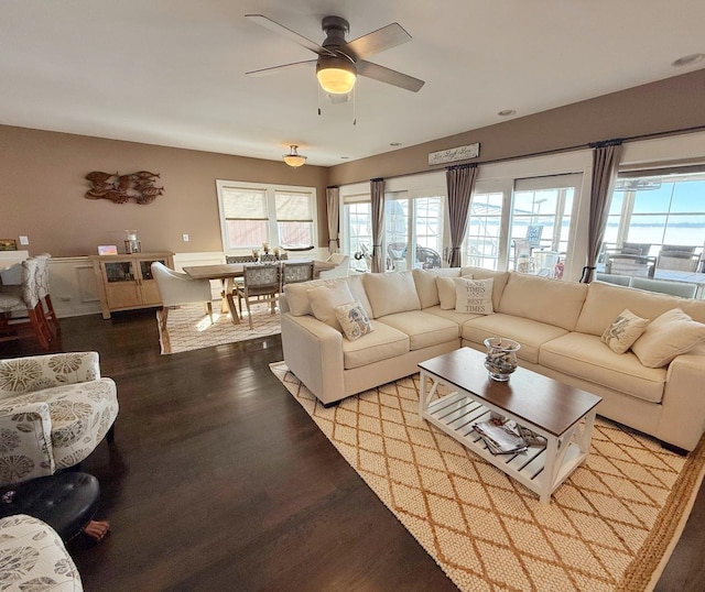 living room featuring wood finished floors, healthy amount of natural light, and ceiling fan
