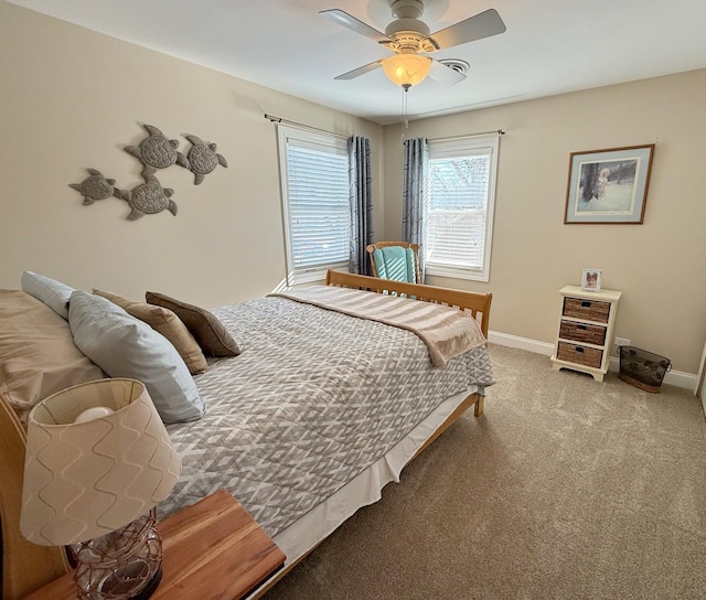carpeted bedroom featuring baseboards and ceiling fan