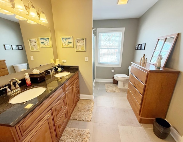 full bath with toilet, an enclosed shower, tile patterned floors, baseboards, and double vanity