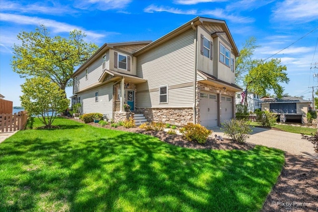 view of front of home with a garage, stone siding, and driveway