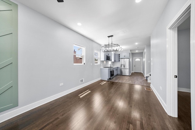 7414 S Aberdeen St, Chicago, IL 60621 - unfurnished living room featuring dark wood-type flooring, a chandelier, recessed lighting, and baseboards