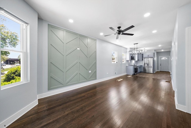 7414 S Aberdeen St, Chicago, IL 60621 - unfurnished living room with baseboards, dark wood-type flooring, a chandelier, and recessed lighting