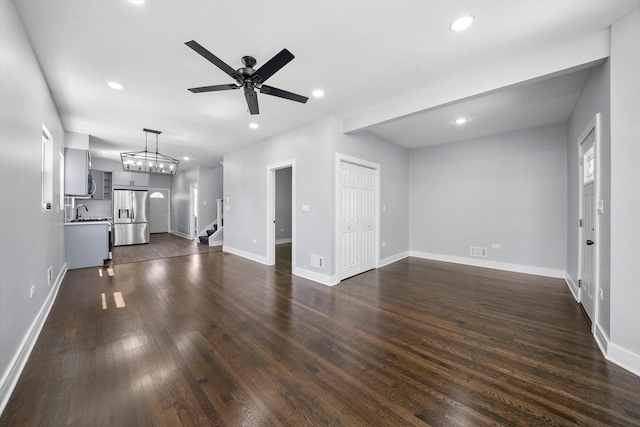 7414 S Aberdeen St, Chicago, IL 60621 - unfurnished living room with stairway, dark wood-type flooring, ceiling fan, recessed lighting, and baseboards