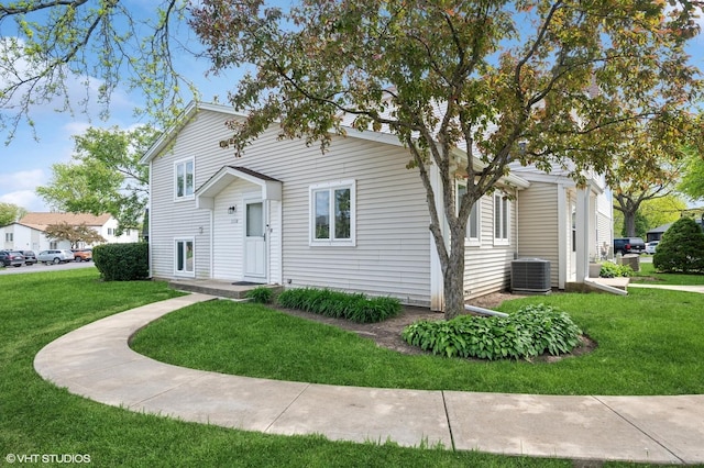 view of front of property featuring central air condition unit and a front yard