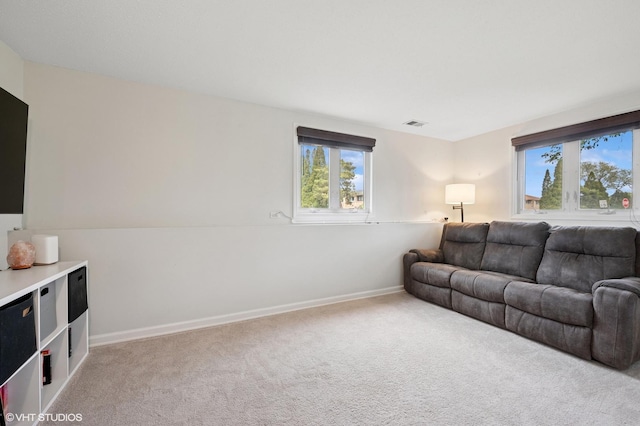 living room with healthy amount of natural light, carpet floors, and baseboards