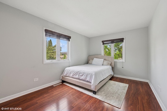 bedroom with wood finished floors and baseboards