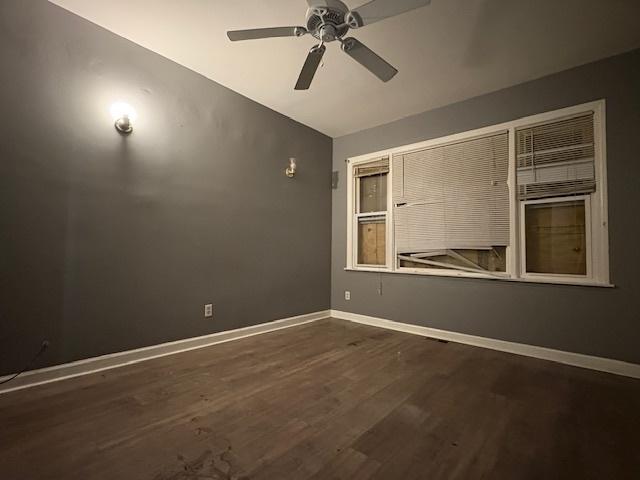 8509 S Muskegon Ave, Chicago, IL 60617 - empty room featuring ceiling fan, dark wood-style flooring, lofted ceiling, and baseboards