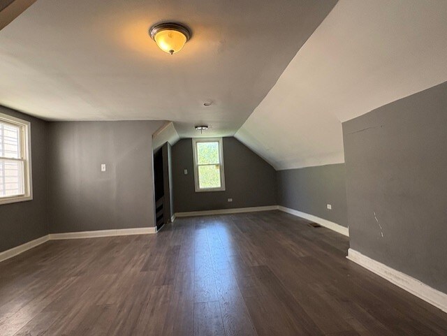 8509 S Muskegon Ave, Chicago, IL 60617 - bonus room with dark wood-type flooring, vaulted ceiling, and baseboards
