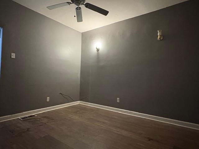 8509 S Muskegon Ave, Chicago, IL 60617 - spare room featuring ceiling fan, wood finished floors, and baseboards