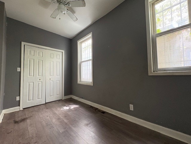 8509 S Muskegon Ave, Chicago, IL 60617 - unfurnished bedroom with wood finished floors, baseboards, a closet, and ceiling fan