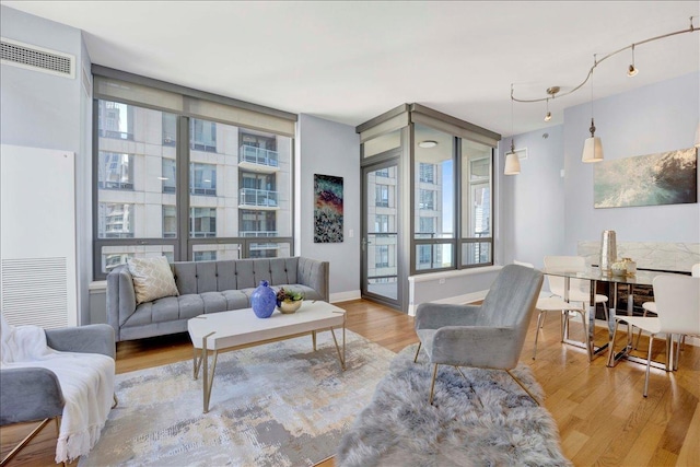 living room featuring wood finished floors and baseboards