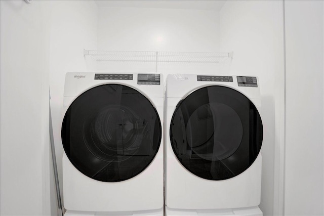 washroom with washing machine and clothes dryer