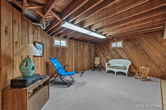 unfurnished room with carpet and wood walls