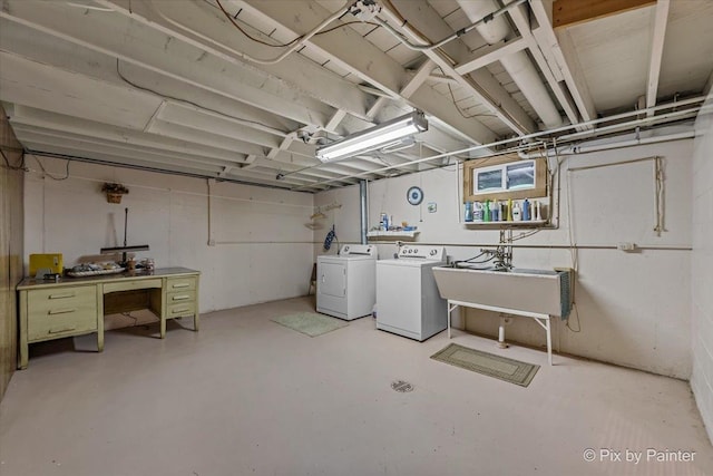 unfinished basement featuring independent washer and dryer and a sink