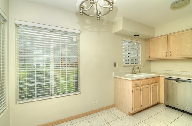 kitchen with dishwasher, a sink, light brown cabinetry, a chandelier, and light tile patterned floors