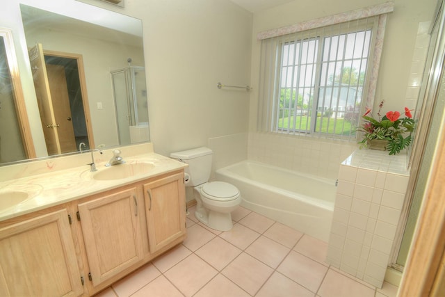 full bath featuring tile patterned flooring, toilet, a shower with door, double vanity, and a tub