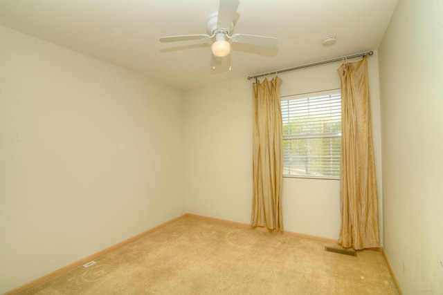 unfurnished room with light colored carpet, baseboards, a ceiling fan, and a smoke detector