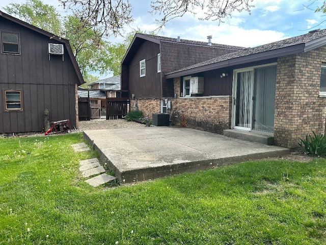 14315 S 92nd St, Orland Park, IL 60462 - back of property with brick siding, a patio area, roof with shingles, central air condition unit, and a gambrel roof
