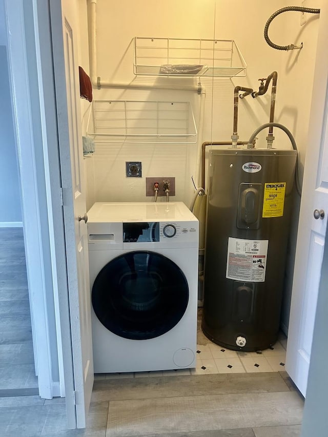 clothes washing area with washer / clothes dryer and water heater
