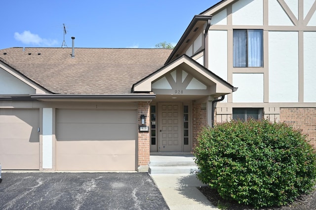 928 Surrey Dr Unit 1A, Schaumburg, IL 60193 - view of front of property featuring brick siding, a shingled roof, and driveway