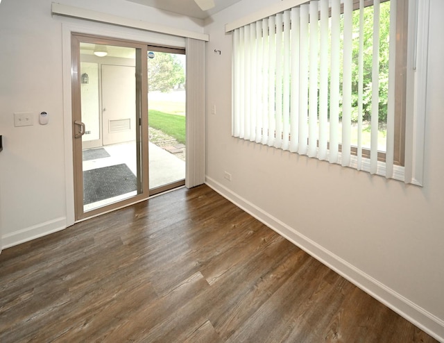 928 Surrey Dr Unit 1A, Schaumburg, IL 60193 - empty room featuring baseboards and dark wood-style flooring