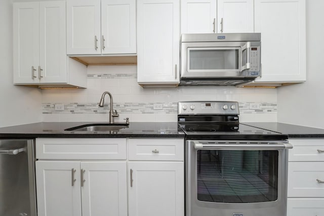 4800 S Chicago Beach Dr Unit 1007N, Chicago, IL 60615 - kitchen featuring appliances with stainless steel finishes, a sink, decorative backsplash, white cabinets, and dark stone countertops
