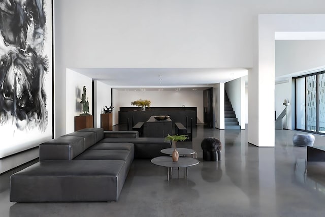 3845 S Winchester Ave, Chicago, IL 60609 - living room featuring stairs, concrete flooring, and a towering ceiling