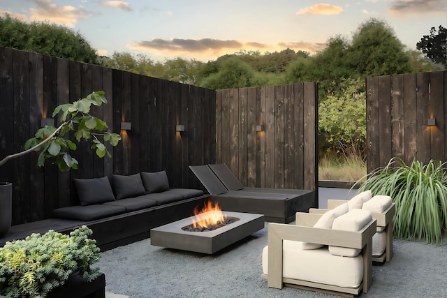 3845 S Winchester Ave, Chicago, IL 60609 - patio terrace at dusk featuring an outdoor living space with a fire pit and fence