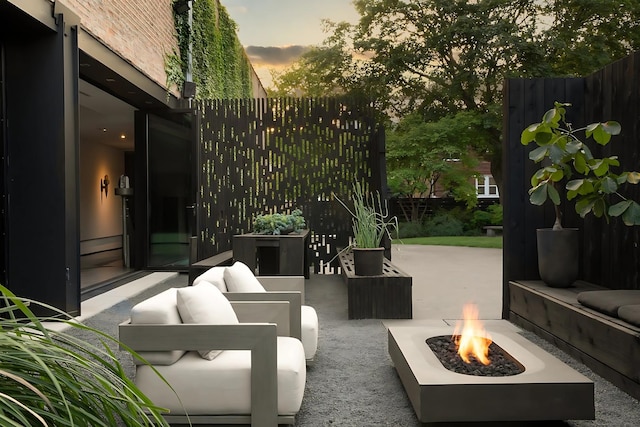 3845 S Winchester Ave, Chicago, IL 60609 - patio terrace at dusk featuring an outdoor living space with a fire pit