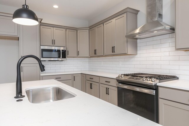 1904 Dunraven Rd, Bloomington, IL 61704 - kitchen featuring stainless steel appliances, wall chimney range hood, gray cabinets, a sink, and hanging light fixtures