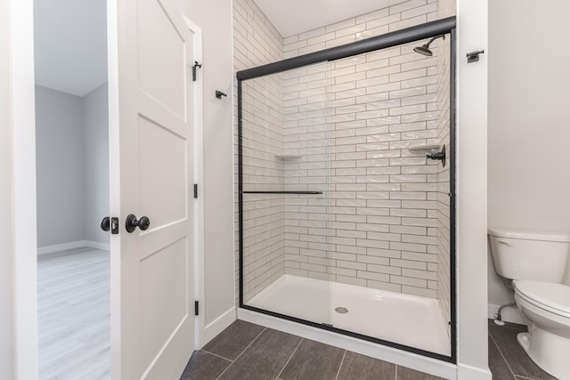 1904 Dunraven Rd, Bloomington, IL 61704 - full bath featuring a shower stall, toilet, baseboards, and wood finished floors