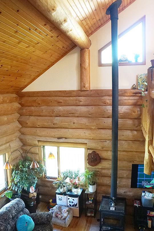 3526 E 2179th Rd, Ottawa, IL 61350 - living area featuring a wood stove, log walls, wood ceiling, and wood finished floors