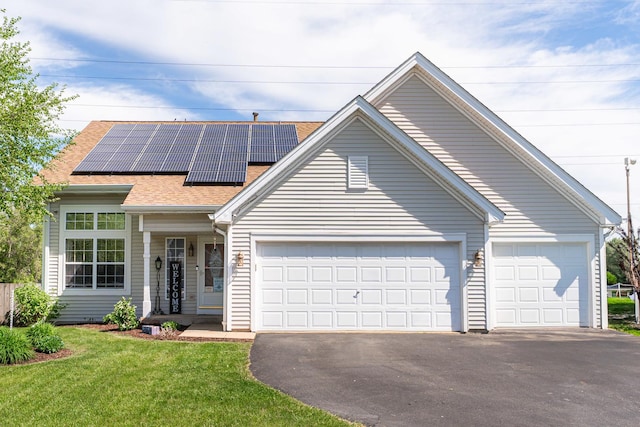 2124 Northwood Dr, Belvidere, IL 61008 - single story home featuring asphalt driveway, roof mounted solar panels, a front yard, roof with shingles, and a garage