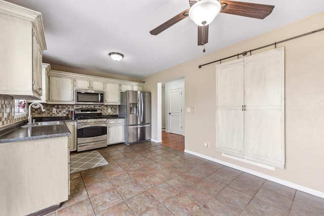 2124 Northwood Dr, Belvidere, IL 61008 - kitchen with appliances with stainless steel finishes, a sink, dark countertops, and baseboards