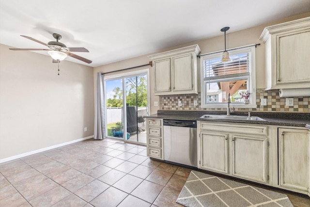 2124 Northwood Dr, Belvidere, IL 61008 - kitchen featuring dishwasher, a sink, dark countertops, and backsplash