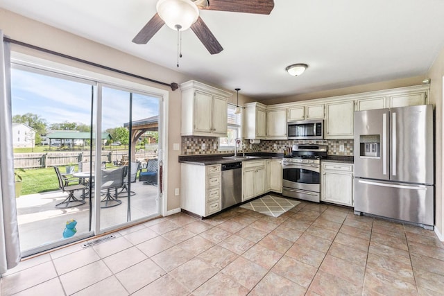 2124 Northwood Dr, Belvidere, IL 61008 - kitchen with stainless steel appliances, dark countertops, backsplash, and a sink